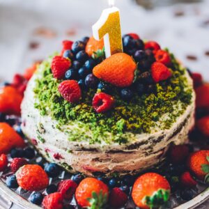 Birthday cake with one year figure and fresh fruits